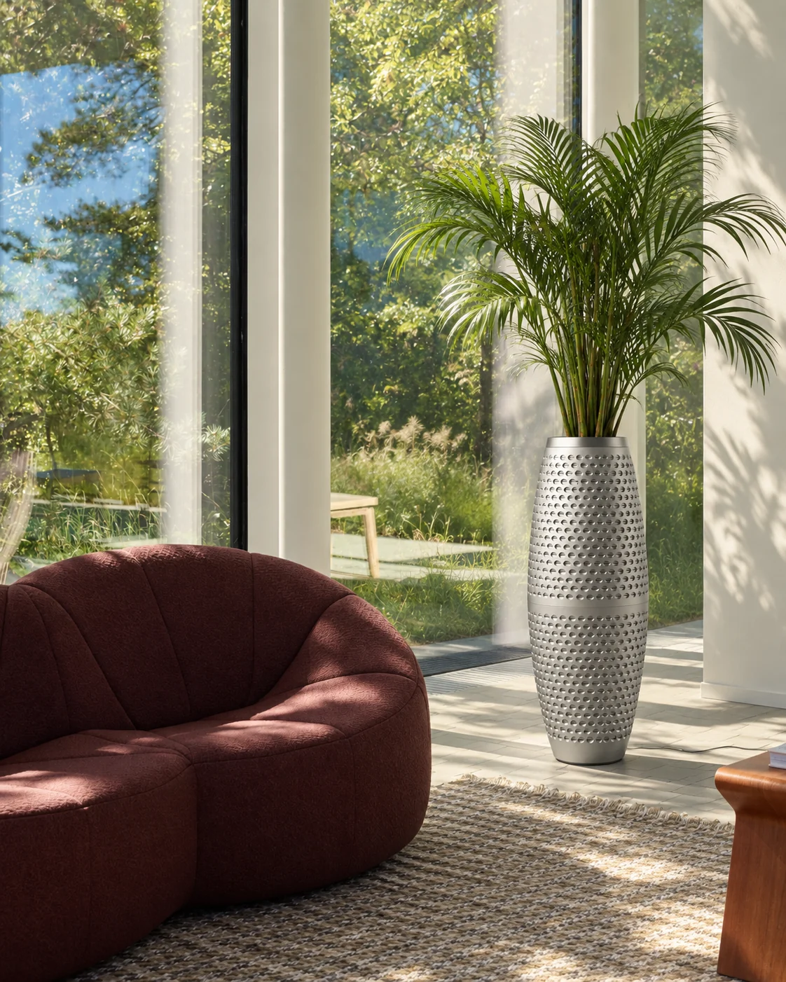 Purispira Pro by a tall window beside a rust-red sofa in a sunlit living room